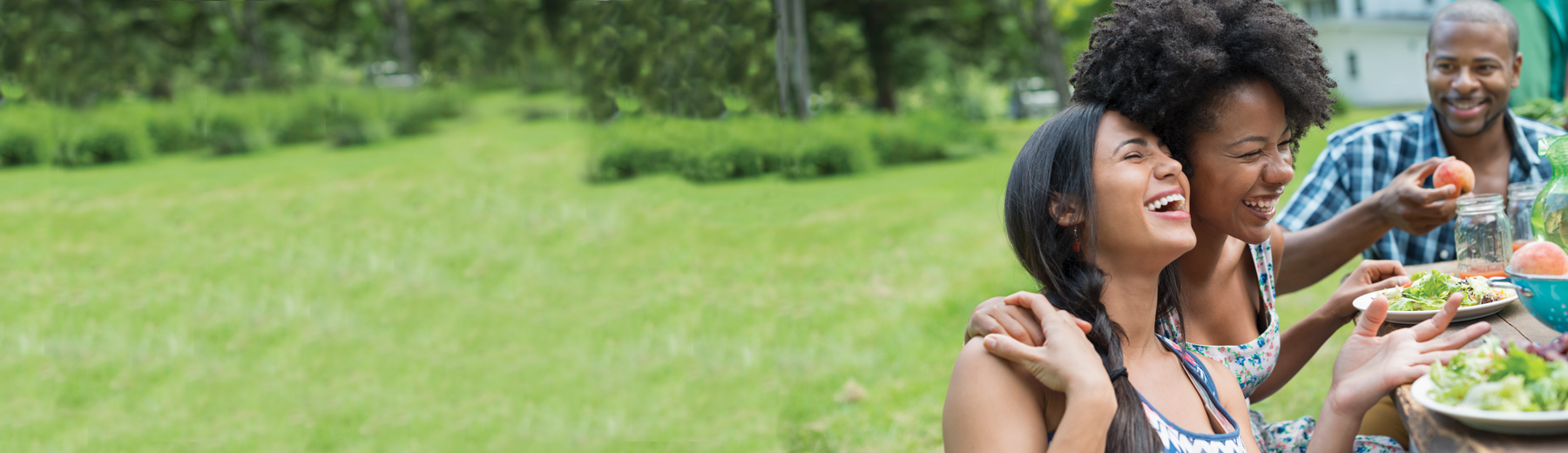 Friends smiling at a park
