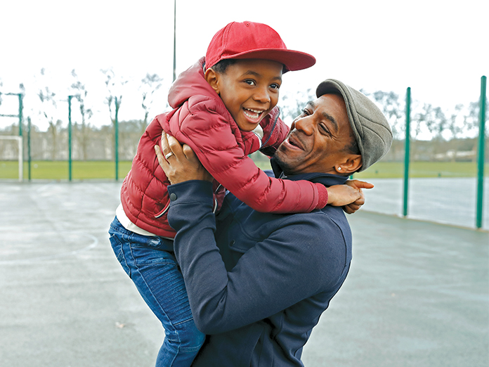 Father and son playing and smiling together